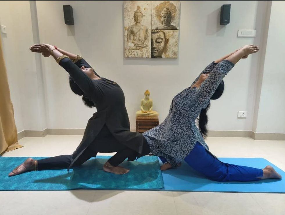 Two women practicing yoga